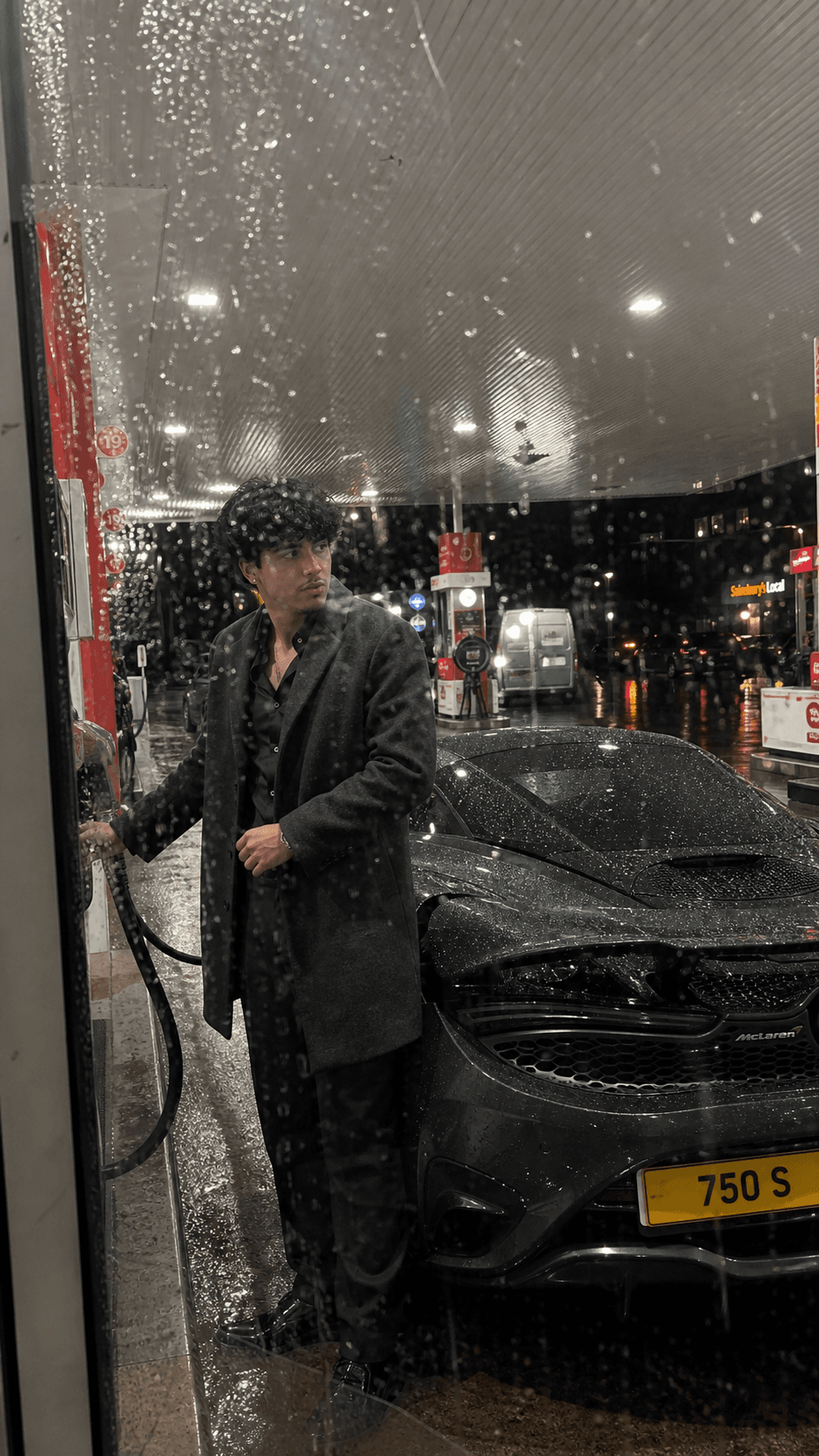 AI-generated roadside stop with a man and a McLaren at a petrol station