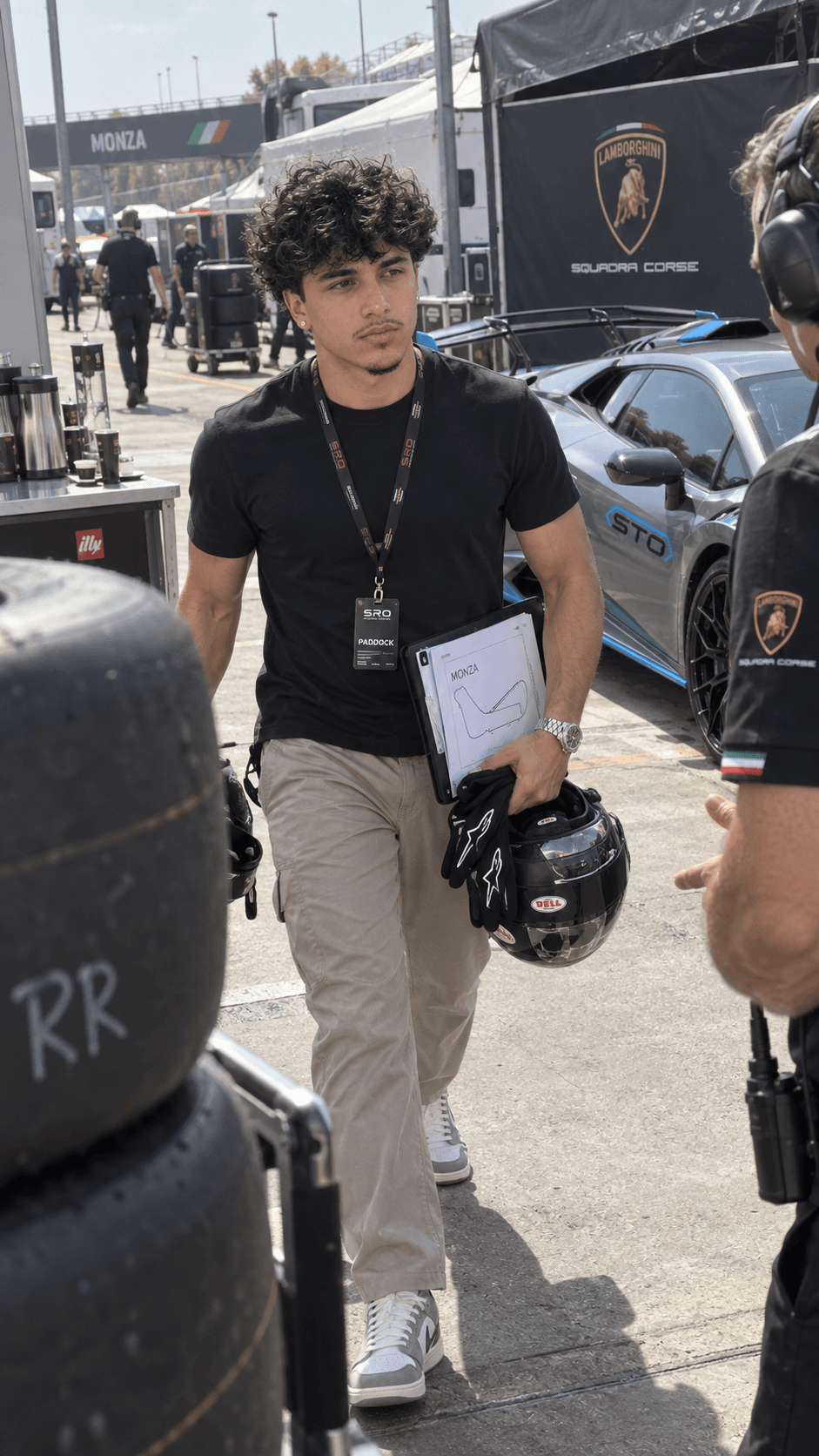 AI-generated man carrying a racing helmet and timing folder beside a Lamborghini Huracan STO in a private circuit paddock